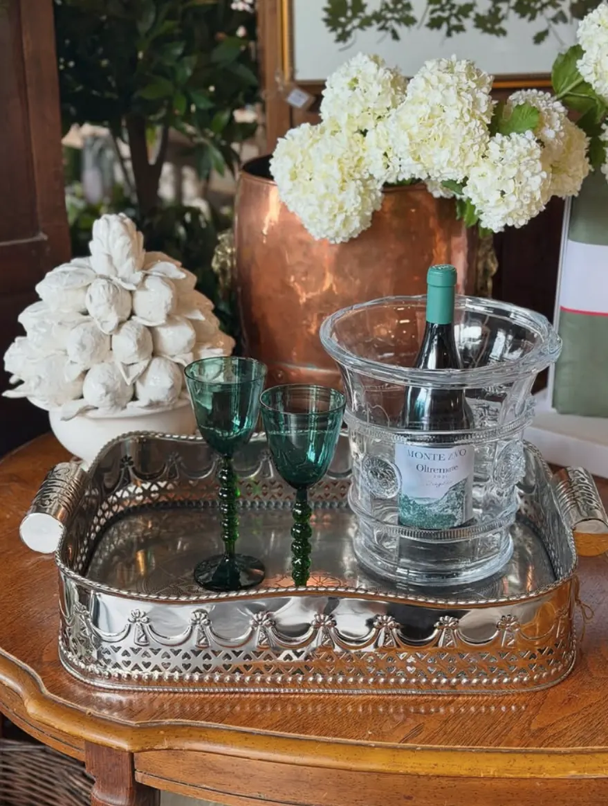 Holiday tablesetting with hurricane candles and greenery