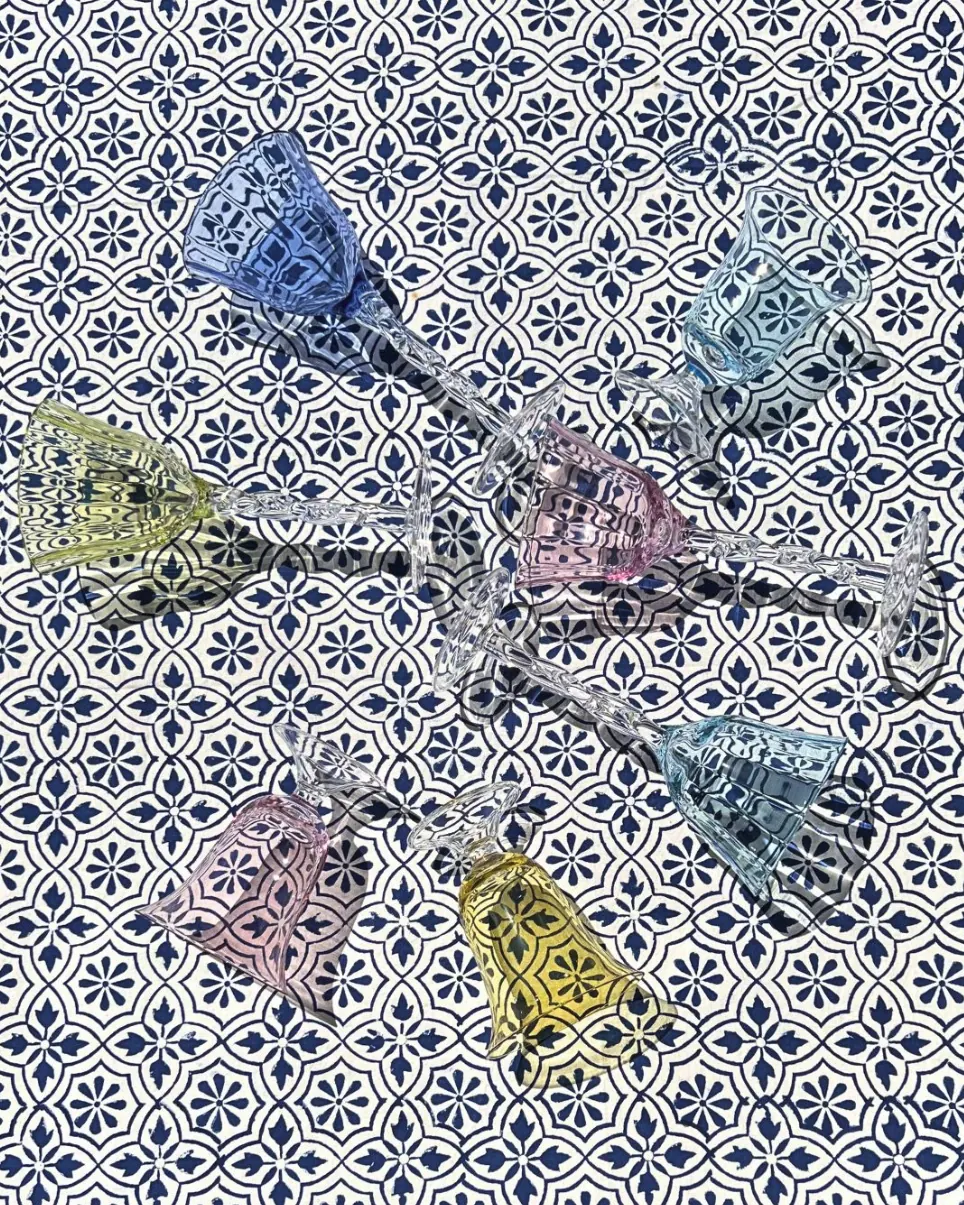 Close-up of embroidered linen napkins folded on a plate